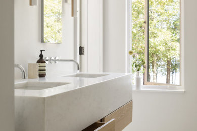 Inspiration for a modern master marble floor and double-sink bathroom remodel in Portland Maine with flat-panel cabinets, light wood cabinets, an undermount sink, marble countertops, white countertops and a floating vanity