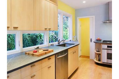 This is an example of a small modern galley separate kitchen in San Francisco with an undermount sink, flat-panel cabinets, light wood cabinets, blue splashback, ceramic splashback, stainless steel appliances, light hardwood floors and no island.