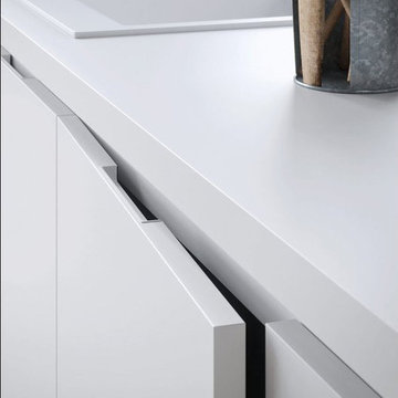 Modern white and light wood kitchen with wood table top