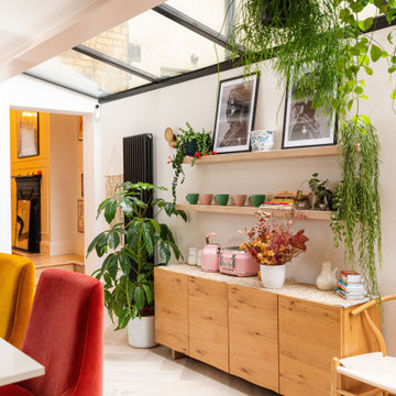 Colourful Kitchen Diner with Bold Green Cabinets and Pink Island