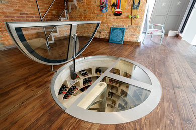 Photo of a mid-sized eclectic wine cellar in Oxfordshire with concrete floors, diamond bins and grey floor.