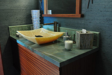 Large island style bathroom photo in Hawaii with brown cabinets, a vessel sink, green countertops and quartzite countertops