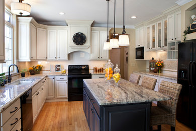 Inspiration for a transitional enclosed kitchen remodel in St Louis with an undermount sink, raised-panel cabinets, white cabinets, granite countertops, subway tile backsplash and black appliances