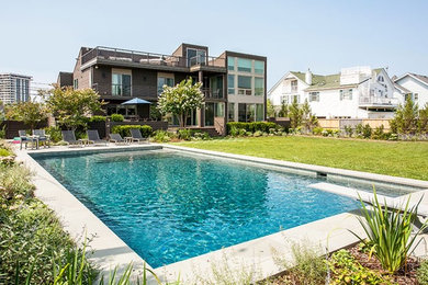 This is an example of a large transitional full sun backyard concrete paver landscaping in New York for summer.