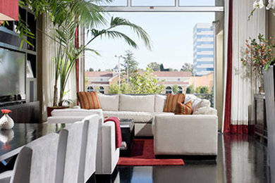 Example of a huge minimalist black floor great room design in Orange County with no fireplace