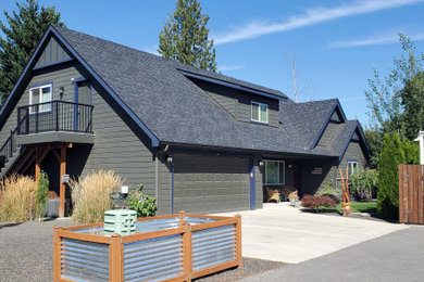 Mid-sized trendy green two-story wood and clapboard exterior home photo in Seattle with a shingle roof and a black roof