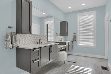 Inspiration for a large contemporary master white tile and mosaic tile ceramic tile and gray floor walk-in shower remodel in Other with recessed-panel cabinets, gray cabinets, an undermount tub, a bidet, blue walls, an undermount sink, quartz countertops, a hinged shower door and white countertops
