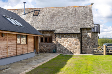 Design ideas for a medium sized classic bungalow front house exterior in Devon with mixed cladding, an orange house, a pitched roof, a metal roof, a black roof and shiplap cladding.