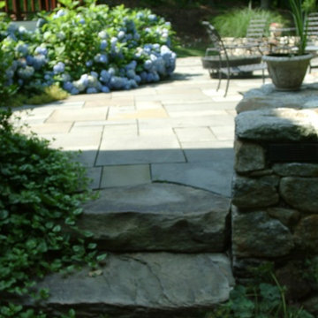 Hydrangeas spill over blue-stone terrace