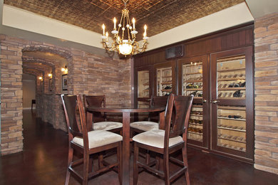 Design ideas for a large traditional wine cellar in Calgary with concrete floors and display racks.
