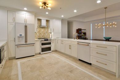 Design ideas for a large transitional u-shaped eat-in kitchen in Miami with an undermount sink, shaker cabinets, white cabinets, quartz benchtops, multi-coloured splashback, ceramic splashback, white appliances, travertine floors, with island, beige floor, white benchtop and coffered.