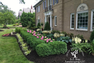This is an example of a mid-sized traditional partial sun front yard formal garden in Cleveland for summer.