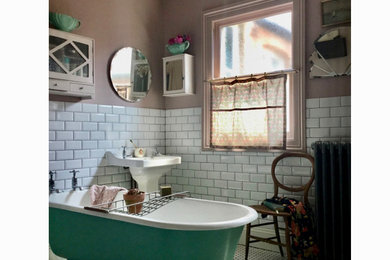 Design ideas for a medium sized traditional bathroom in Other with a claw-foot bath, white tiles, pink walls, a pedestal sink, white floors and a freestanding vanity unit.