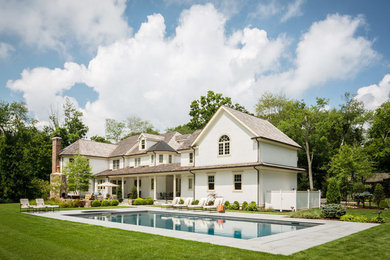 Inspiration for a large timeless backyard stone and rectangular lap hot tub remodel in New York