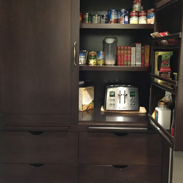Pantry breakfast cabinet with plugged in toaster and cutting boards
