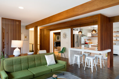 Example of a mid-sized 1950s l-shaped dark wood floor and black floor open concept kitchen design in Omaha with a double-bowl sink, flat-panel cabinets, white cabinets, laminate countertops, white backsplash, stainless steel appliances and two islands