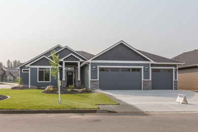 Example of a classic blue one-story vinyl house exterior design in Other with a gambrel roof and a shingle roof
