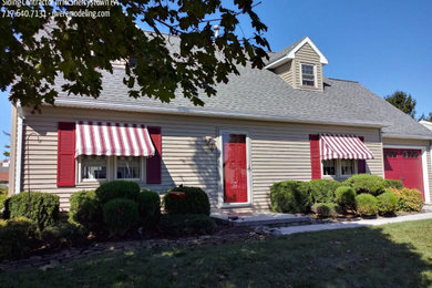 Inspiration for a mid-sized timeless beige two-story vinyl exterior home remodel in Other with a shingle roof