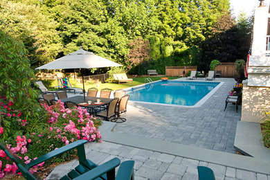 Photo of a modern rectangular pool in New York with concrete pavers.
