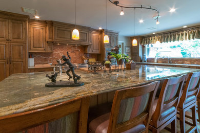 Large mountain style u-shaped light wood floor eat-in kitchen photo in Other with an integrated sink, beaded inset cabinets, distressed cabinets, granite countertops, orange backsplash, stone slab backsplash, stainless steel appliances and an island