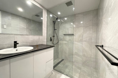 Photo of a small modern 3/4 bathroom in Cairns with flat-panel cabinets, an open shower, a drop-in sink, an open shower and a built-in vanity.