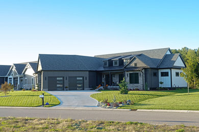 Example of a large transitional white one-story mixed siding and board and batten exterior home design in Other with a shingle roof and a gray roof