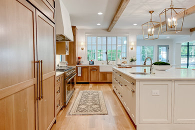 Transitional eat-in kitchen in Atlanta with an undermount sink, recessed-panel cabinets, medium wood cabinets, white splashback, light hardwood floors, with island, white benchtop and exposed beam.