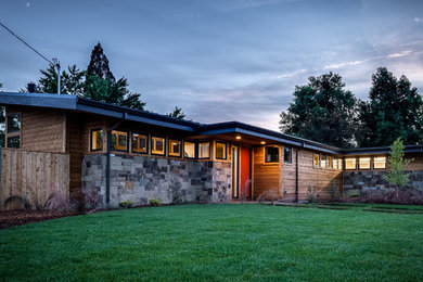 Mid-sized 1950s multicolored one-story mixed siding house exterior idea in Portland with a shed roof and a shingle roof