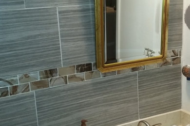 BATHROOM REMODEL RUNNING TILES UP THE WALL WITH MOSSIAC BEAD AND BULLNOSE TRIM