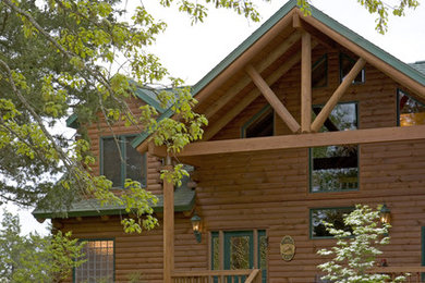 Example of a brown two-story exterior home design in Other