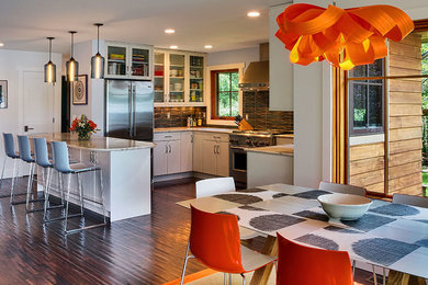 Mid-sized trendy l-shaped medium tone wood floor and brown floor eat-in kitchen photo in New York with an undermount sink, flat-panel cabinets, white cabinets, quartz countertops, blue backsplash, ceramic backsplash, stainless steel appliances and an island