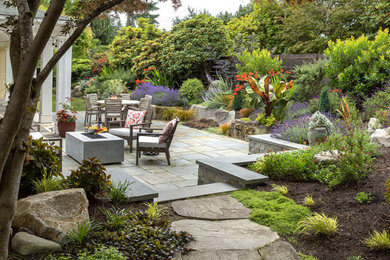 Inspiration for a mid-sized farmhouse drought-tolerant and full sun backyard stone and wood fence landscaping in Seattle.