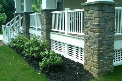 Mid-sized elegant front porch photo in Philadelphia with decking and a roof extension