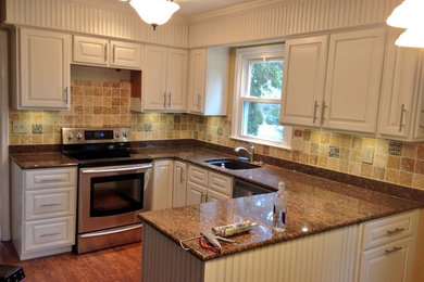 Eat-in kitchen - mid-sized u-shaped dark wood floor eat-in kitchen idea in Philadelphia with an undermount sink, raised-panel cabinets, yellow cabinets, granite countertops, beige backsplash, ceramic backsplash, stainless steel appliances and a peninsula
