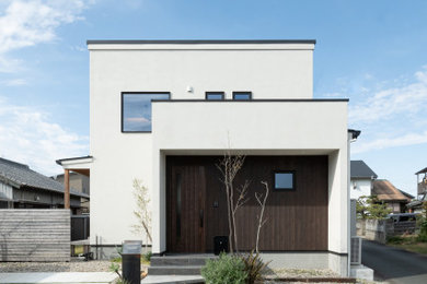 Ejemplo de fachada de casa blanca urbana de dos plantas con tejado plano