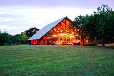 Inspiration for a large rustic brown one-story wood exterior home remodel in Austin with a metal roof