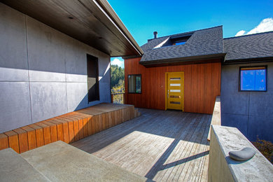 Large modern three-story mixed siding exterior home idea in Seattle with a shingle roof