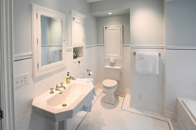 Example of a classic blue tile and ceramic tile porcelain tile and white floor bathroom design in Milwaukee with a two-piece toilet, blue walls, a pedestal sink and a hinged shower door