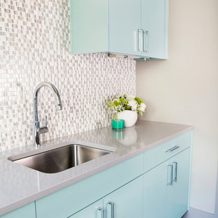 Design ideas for a medium sized classic l-shaped separated utility room in Austin with a submerged sink, flat-panel cabinets, turquoise cabinets, composite countertops, porcelain flooring, brown floors, grey worktops and beige walls.