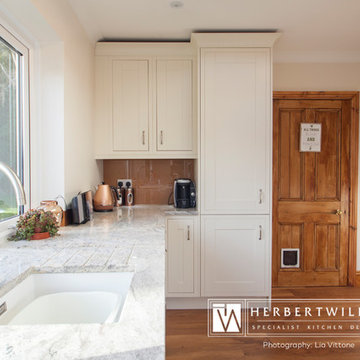 Ivory Mackintosh kitchen with stunning copper glass splashback