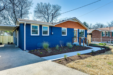 Example of a mid-sized trendy blue one-story brick exterior home design in Nashville with a shingle roof