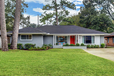 1950s gray one-story brick house exterior photo in Houston with a hip roof and a shingle roof