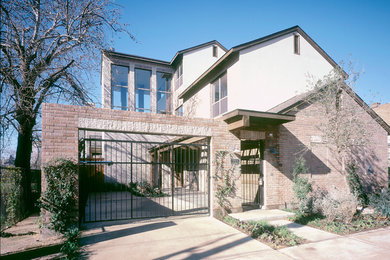 Photo of a mid-sized traditional two-storey brick house exterior in Dallas with a gable roof.