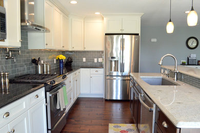 Mid-sized transitional l-shaped dark wood floor open concept kitchen photo in St Louis with an undermount sink, shaker cabinets, white cabinets, granite countertops, gray backsplash, subway tile backsplash, stainless steel appliances and an island
