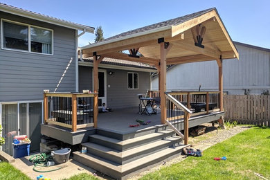 Inspiration for a large transitional backyard deck in Seattle with a pergola.