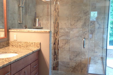 Photo of a large transitional master bathroom in Baltimore with an undermount sink, granite benchtops, flat-panel cabinets, medium wood cabinets, a corner tub, an open shower, a two-piece toilet, beige tile, porcelain tile, beige walls and porcelain floors.