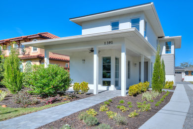 Mid-sized modern white two-story stucco exterior home idea in Orlando