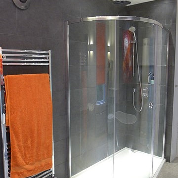 large quadrant shower enclosure with overhead rain shower