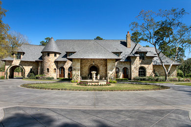 Inspiration for a traditional two-storey exterior in Houston with stone veneer.