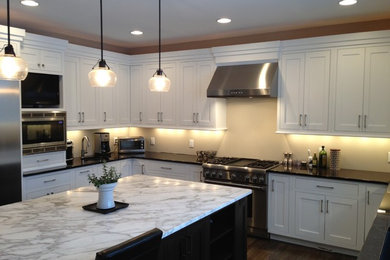 Design ideas for a transitional u-shaped eat-in kitchen in Other with shaker cabinets and white cabinets.